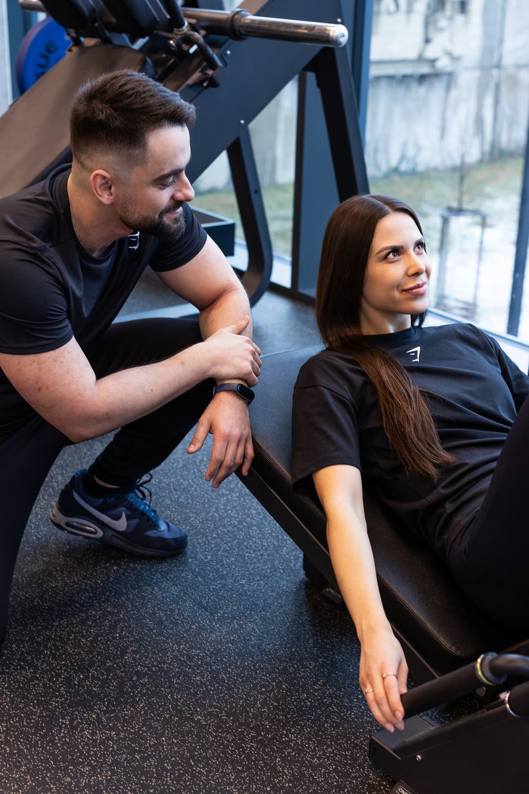 Raul guiding a client through a strength exercise